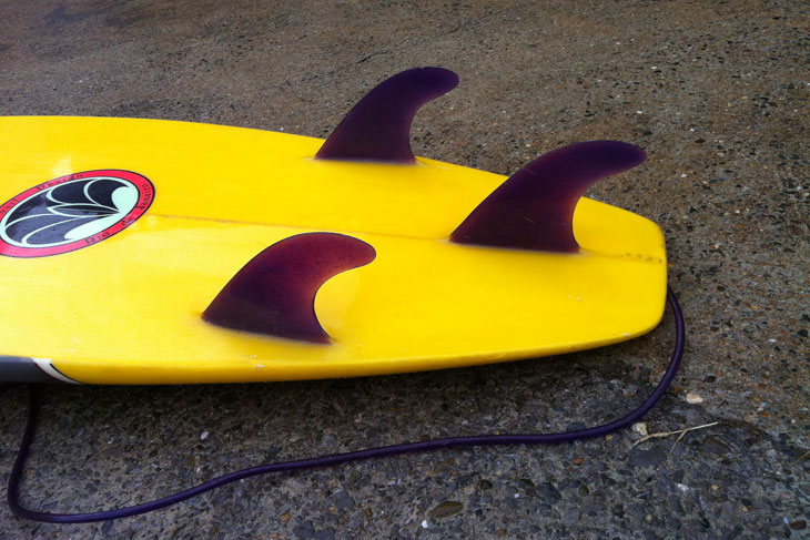 yellow surfboard on the ground